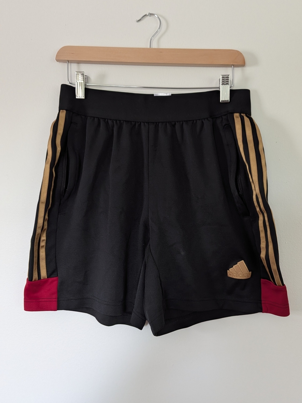 Adidas Black Athletic Shorts with Gold Stripes and Red Accents